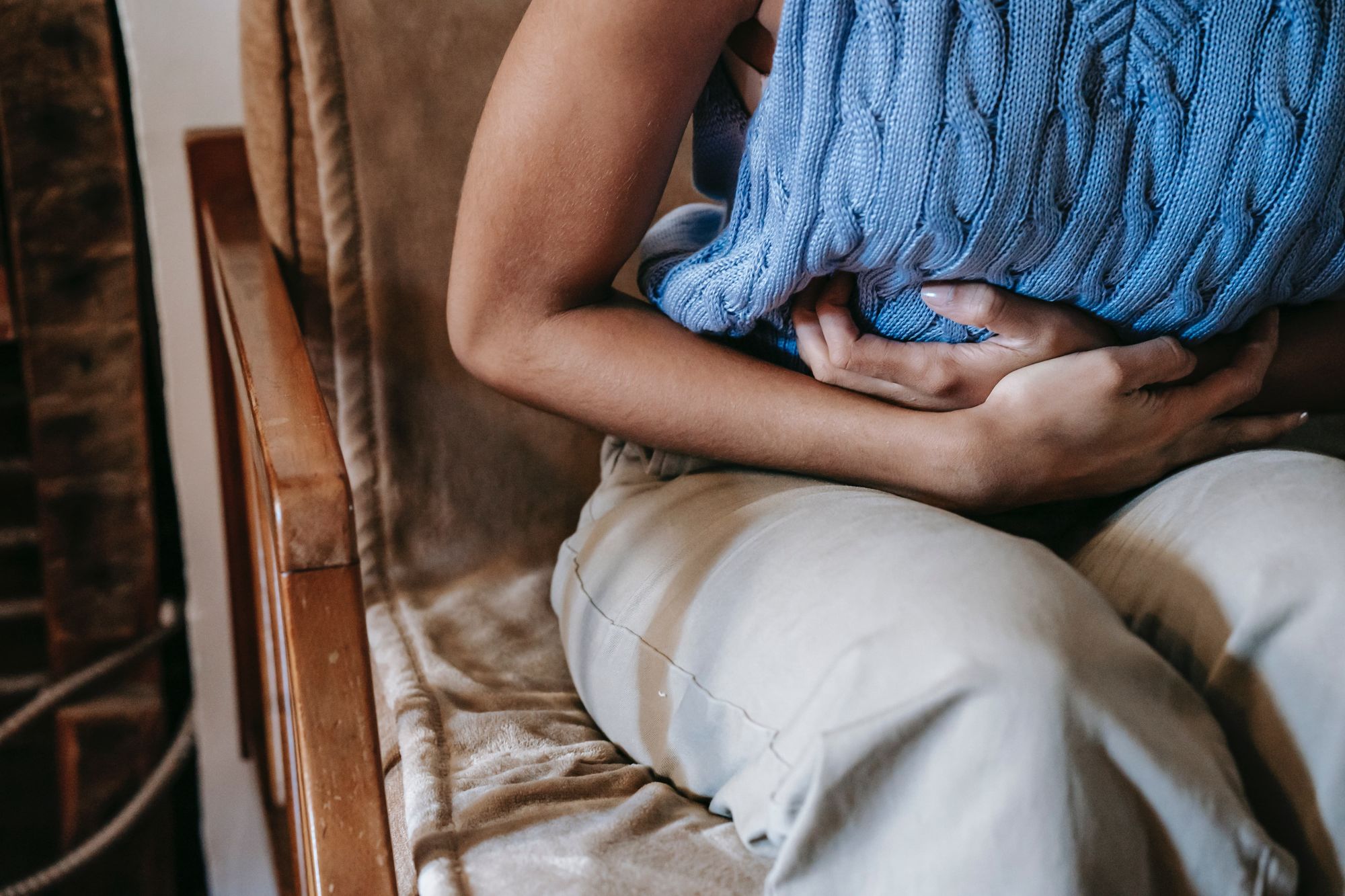 Woman holding her Stomach because of Pain