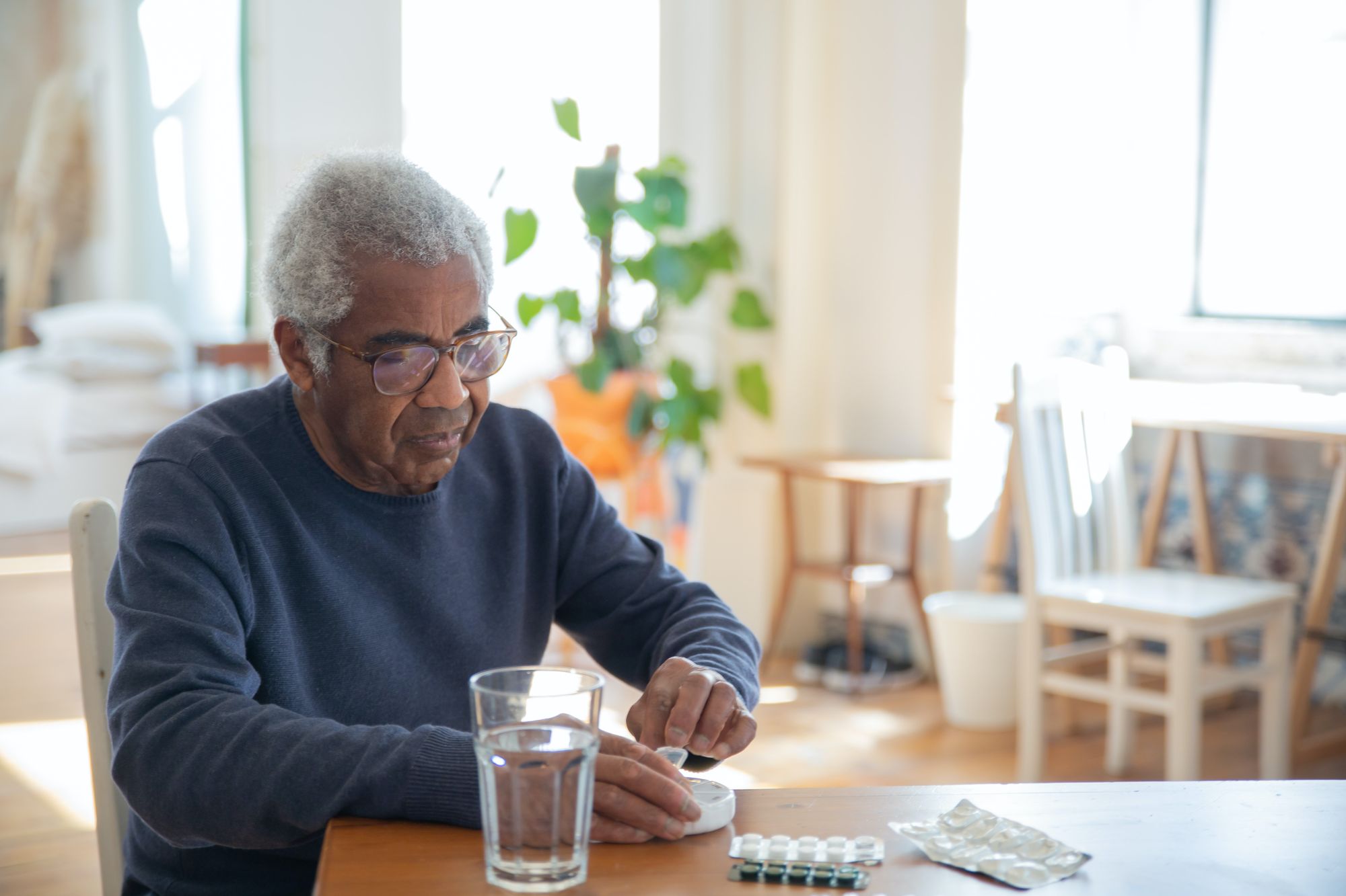 An elderly man using medications
