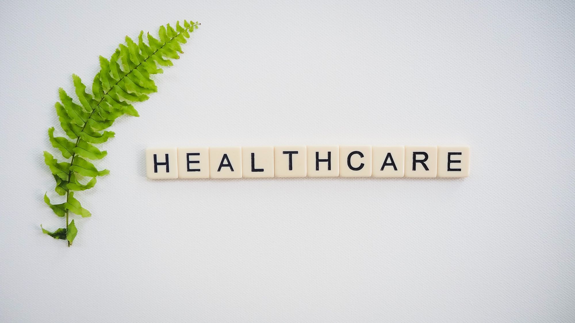 An image showing tiles spelling out "healthcare" with a leaf by the side